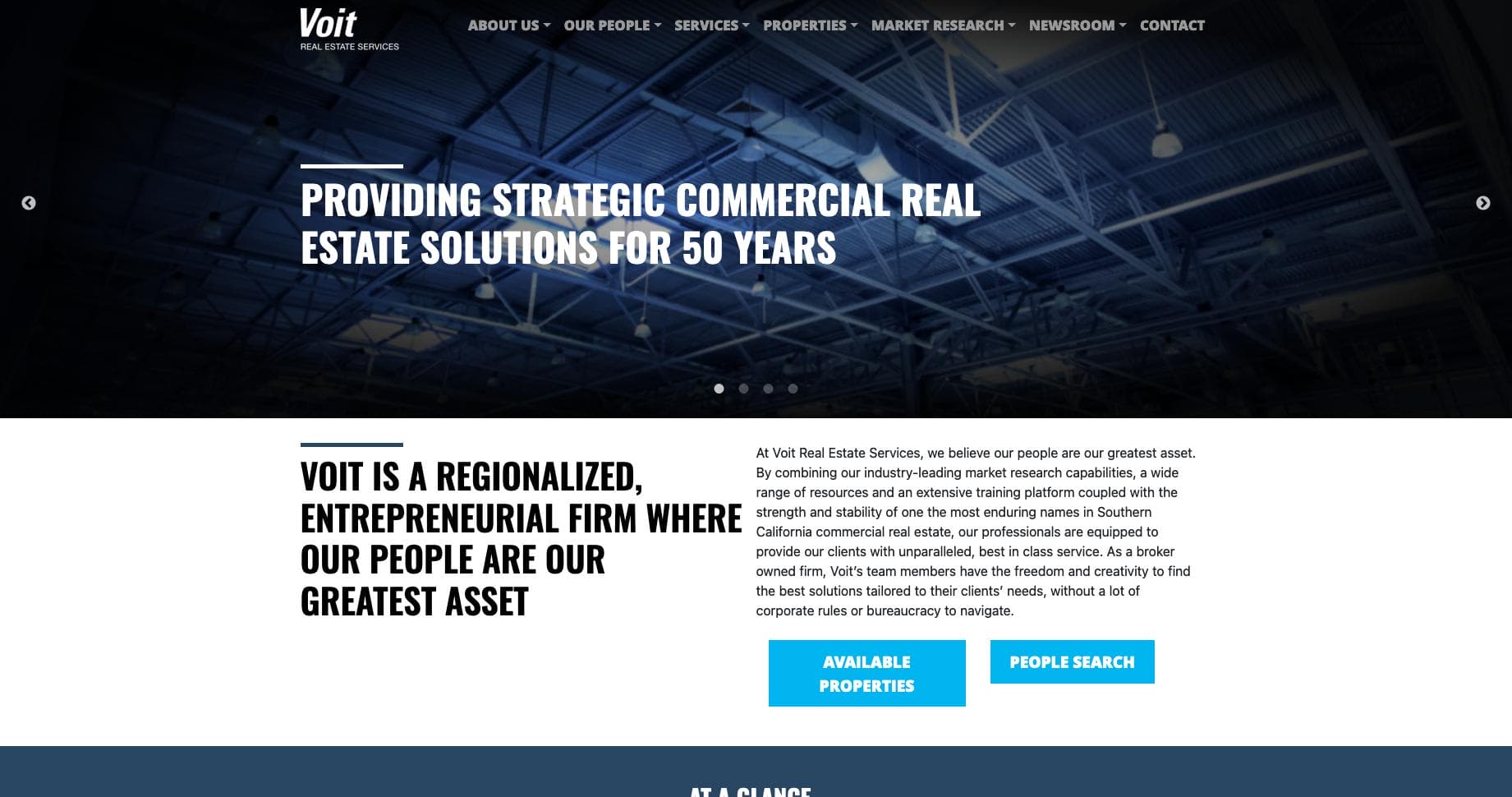 A webpage for Voit Real Estate Services, featuring a banner with a bright warehouse ceiling. Text highlights their 50 years of strategic commercial real estate solutions. Two buttons: "Available Properties" and "People Search" are displayed.
